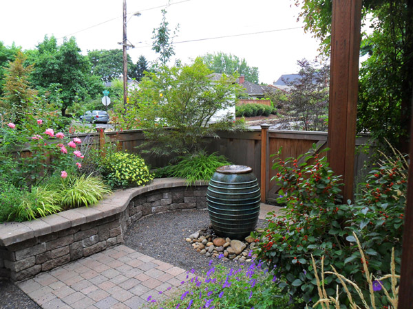 The soothing sound of water draws attention away from the nearby sidewalk in this small urban courtyard oasis. Installation by J. Walter Landscape & Irrigation Contractor.