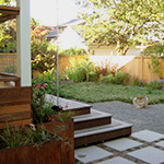 Edibles find a home in this small backyard with a deck and flow through planters for treating storm water.