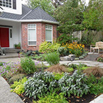 Creative garden layout maximizes the usability of a small yard while creating curb appeal. A new path provides a garden experience to the front door. Hardscape by Pete Wilson Stoneworks, Soil & Planting by J. Walter Landscape & Irrigation Contractor.