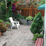 Creating a sunken garden with a living fence provided needed privacy in this small backyard on a corner lot.